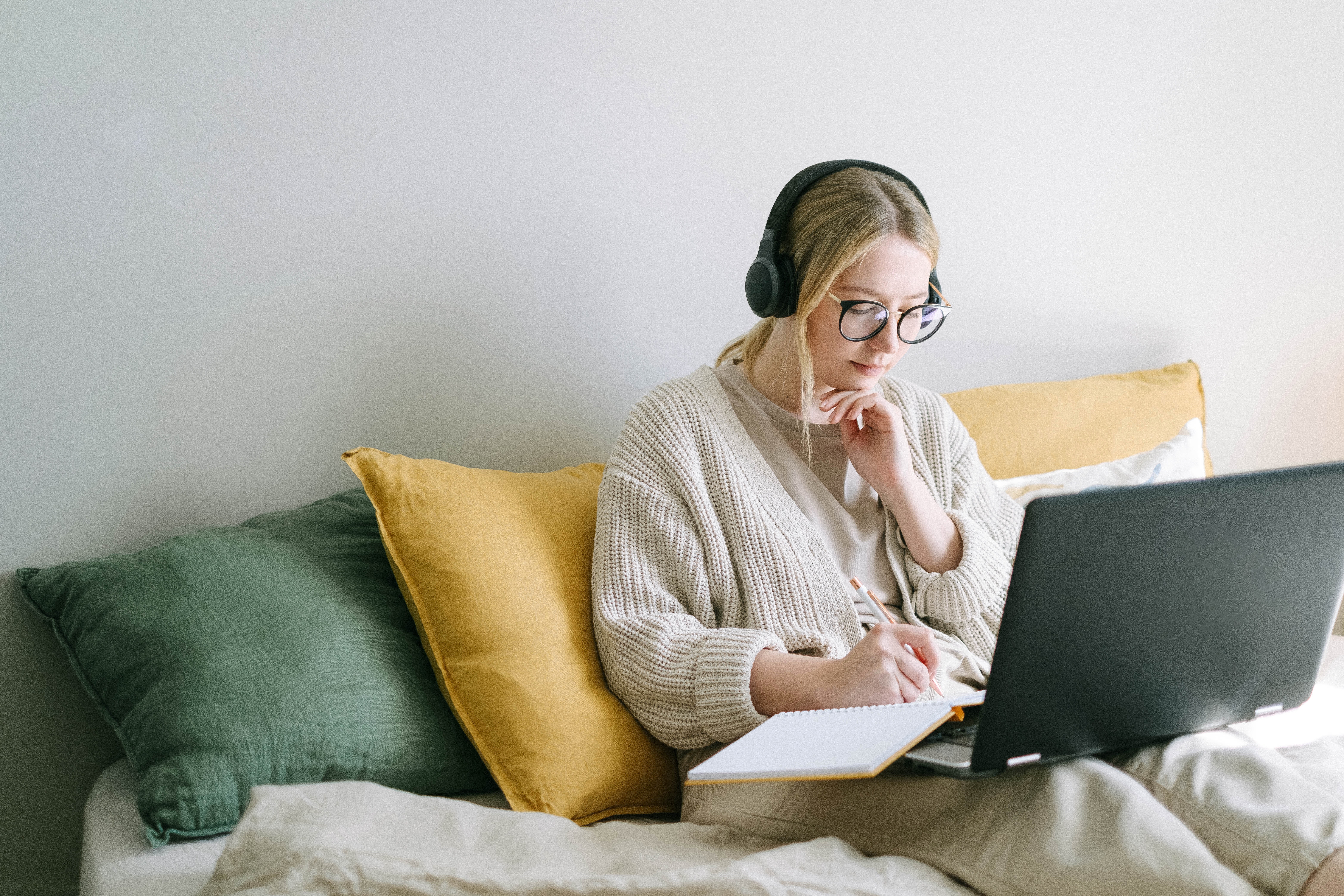 Lady on sofa with her laptop working online in an online business